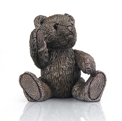 Lot 415 - A silver figure modelled as a seated teddy...