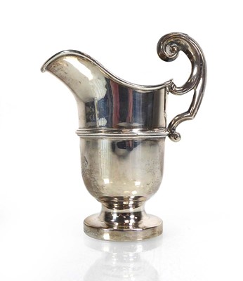 Lot 424 - A metalware cream jug of helmet form, stamped '...