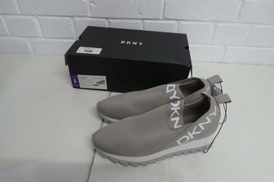 Lot 1129 - A boxed pair of DKNY slip on trainers in warm...