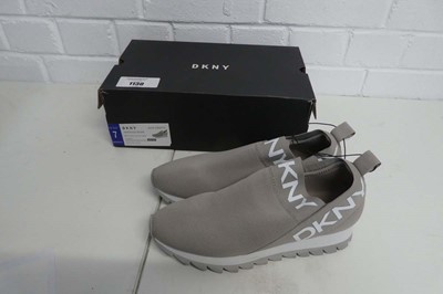 Lot 1130 - A boxed pair of DKNY slip on trainers in warm...