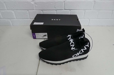 Lot 1133 - A boxed pair of DKNY slip on trainers in black....