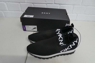 Lot 1134 - A boxed pair of DKNY slip on trainers in black....