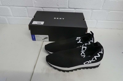 Lot 1136 - A boxed pair of DKNY slip on trainers in black....