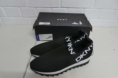 Lot 1137 - A boxed pair of DKNY slip on trainers in black....