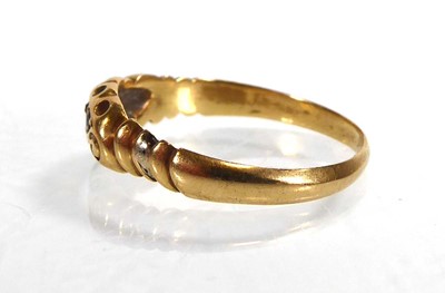 Lot An 18ct yellow gold ring set three graduated...