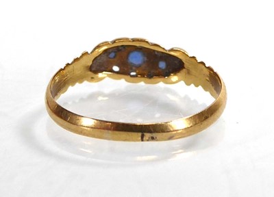 Lot An 18ct yellow gold ring set three graduated...