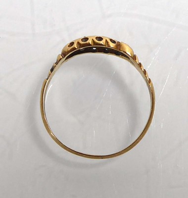 Lot An 18ct yellow gold ring set three graduated...