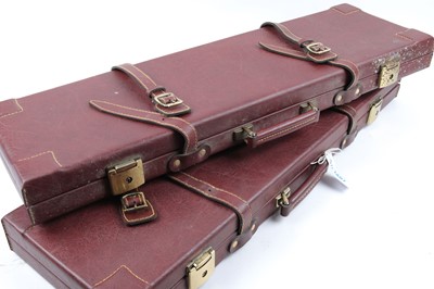 Lot 1407 - Two maroon oxblood vinyl gun cases, fitted...