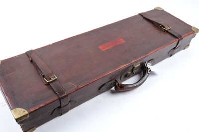 Lot 1411 - Oak and leather gun case embossed D.W.H, brass...