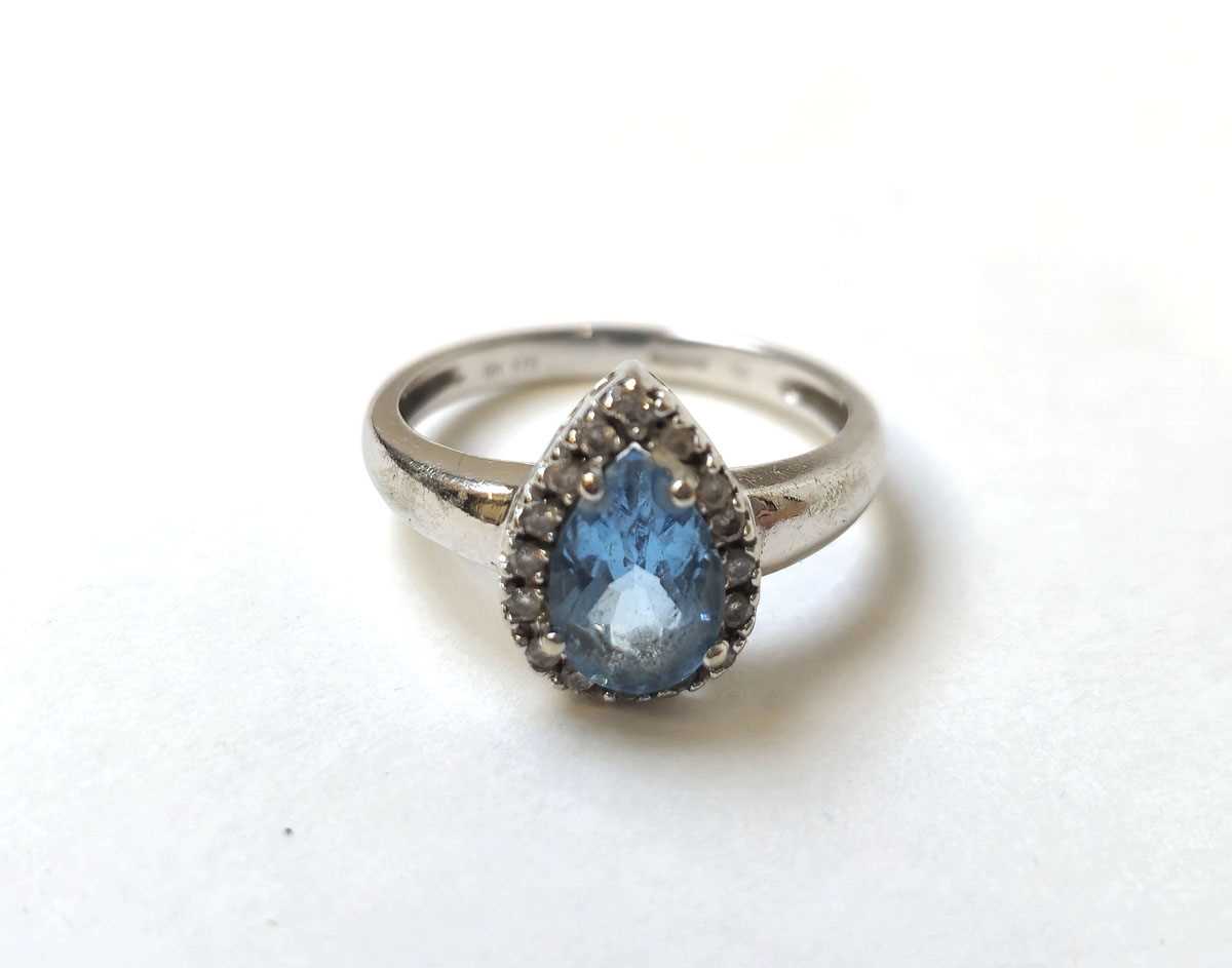 Lot 501 - A 9ct white gold, topaz and diamond pear...