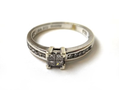 Lot 502 - A 9ct white gold and diamond ring, the four...