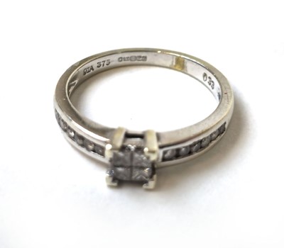 Lot 502 - A 9ct white gold and diamond ring, the four...