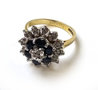 Lot 504 - A 9ct gold, diamond and sapphire cluster ring,...