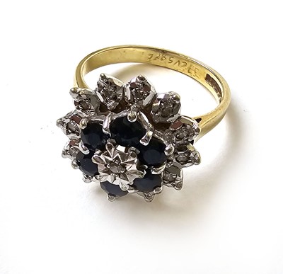 Lot 504 - A 9ct gold, diamond and sapphire cluster ring,...