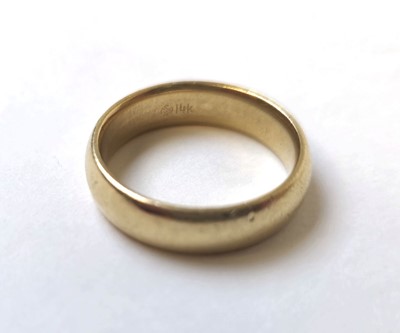 Lot 506 - A yellow metal, court shaped wedding band...