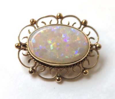 Lot 512 - A 9ct gold and opal brooch with scrolling...