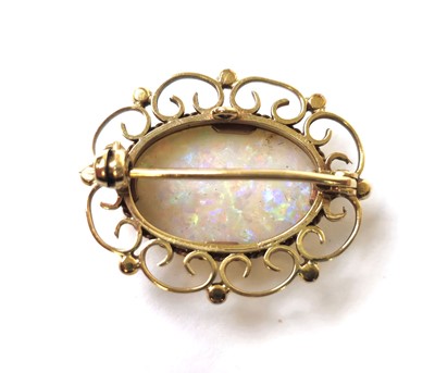 Lot 512 - A 9ct gold and opal brooch with scrolling...