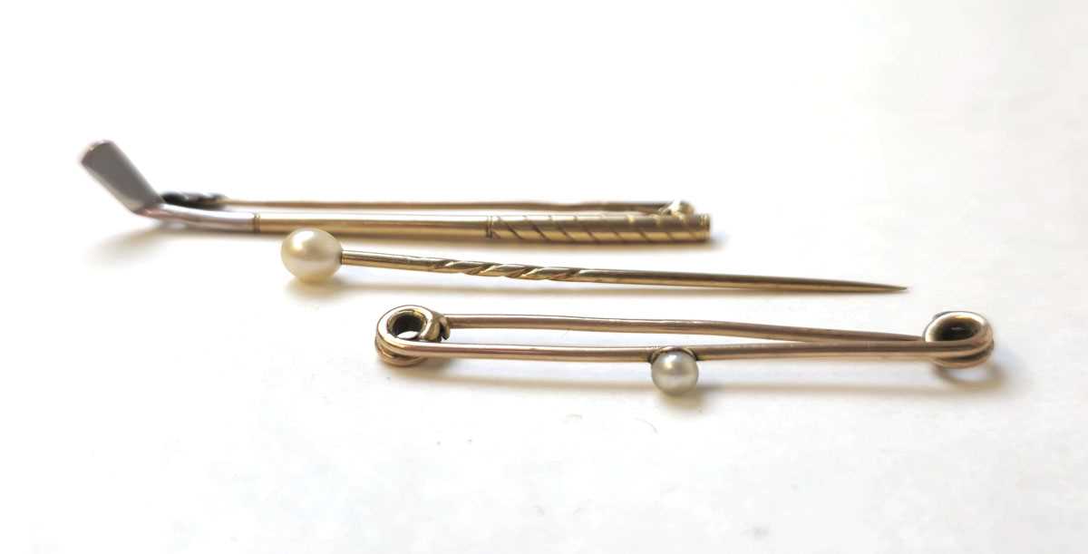 Lot 514 - Two early 20th century yellow metal stick pins...