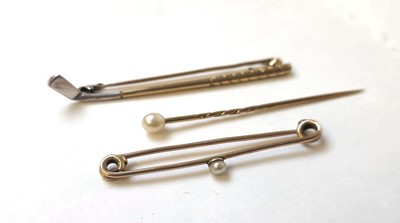 Lot 514 - Two early 20th century yellow metal stick pins...