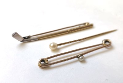 Lot 514 - Two early 20th century yellow metal stick pins...