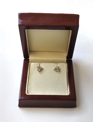 Lot 516 - A pair of white metal and diamond set earrings...