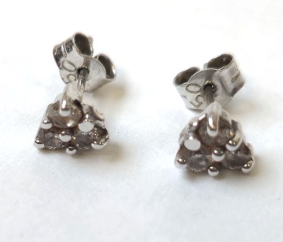 Lot 516 - A pair of white metal and diamond set earrings...