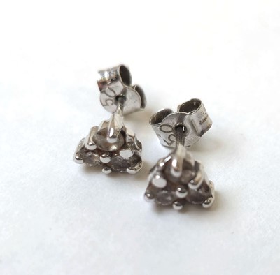 Lot 516 - A pair of white metal and diamond set earrings...