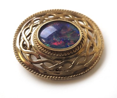 Lot 519 - A 9ct gold and black opal doublet brooch of...