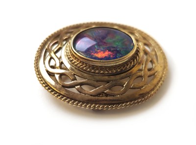 Lot 519 - A 9ct gold and black opal doublet brooch of...