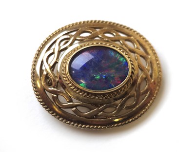 Lot 519 - A 9ct gold and black opal doublet brooch of...