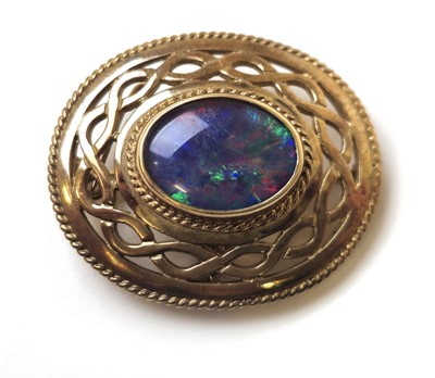 Lot 519 - A 9ct gold and black opal doublet brooch of...