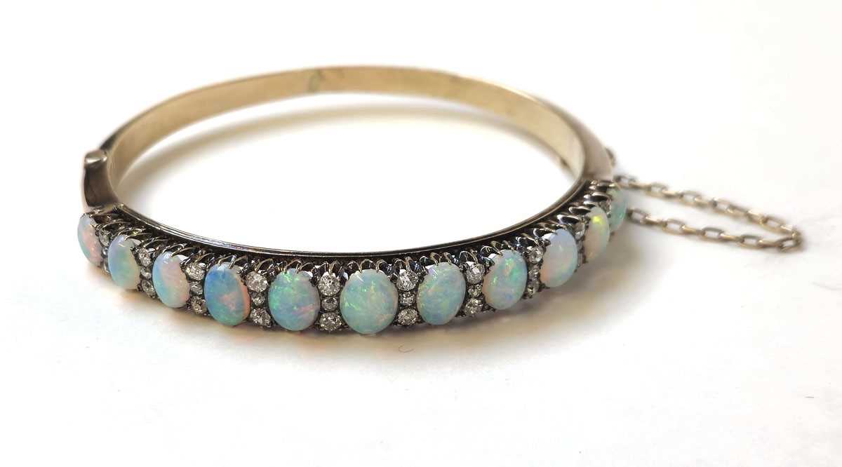 Lot 524 - An early 20th century yellow metal, opal and...