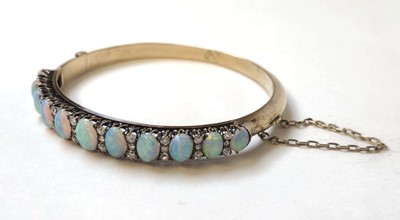 Lot 524 - An early 20th century yellow metal, opal and...