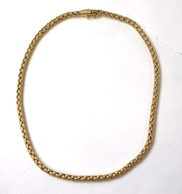 Lot 527 - A yellow metal braided link chain marked...