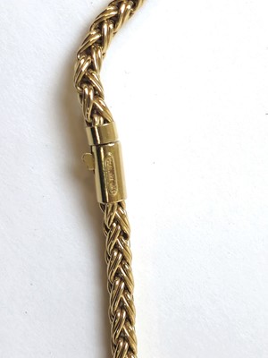 Lot 527 - A yellow metal braided link chain marked...