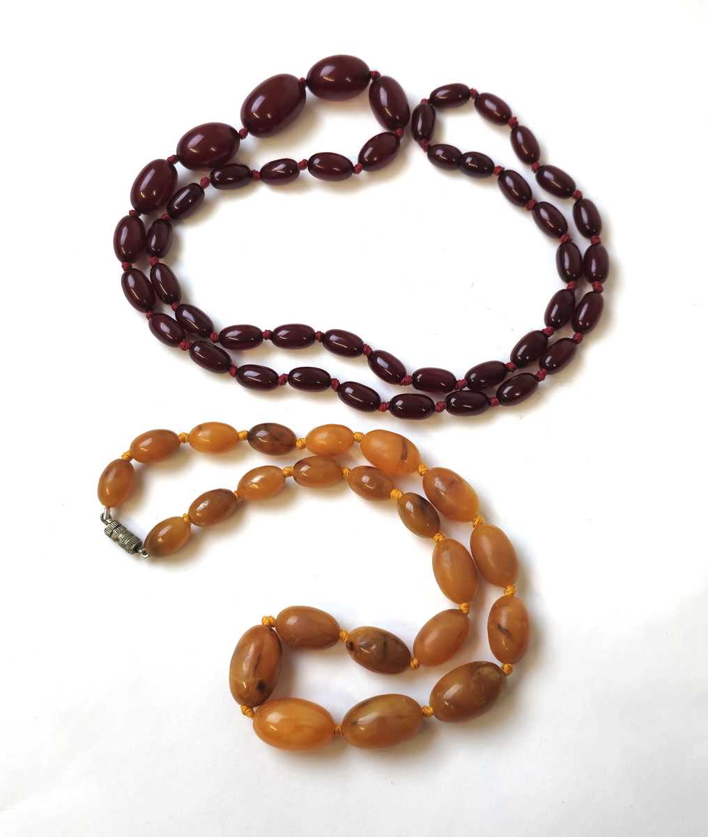 Lot 547 - A string of cherry amber bakelite beads...