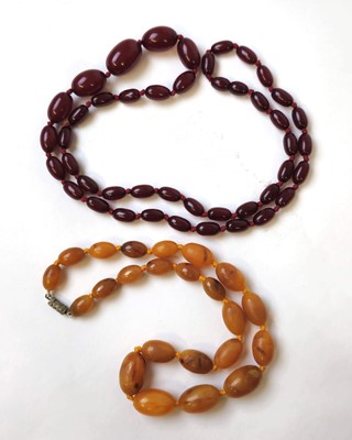 Lot 547 - A string of cherry amber bakelite beads...