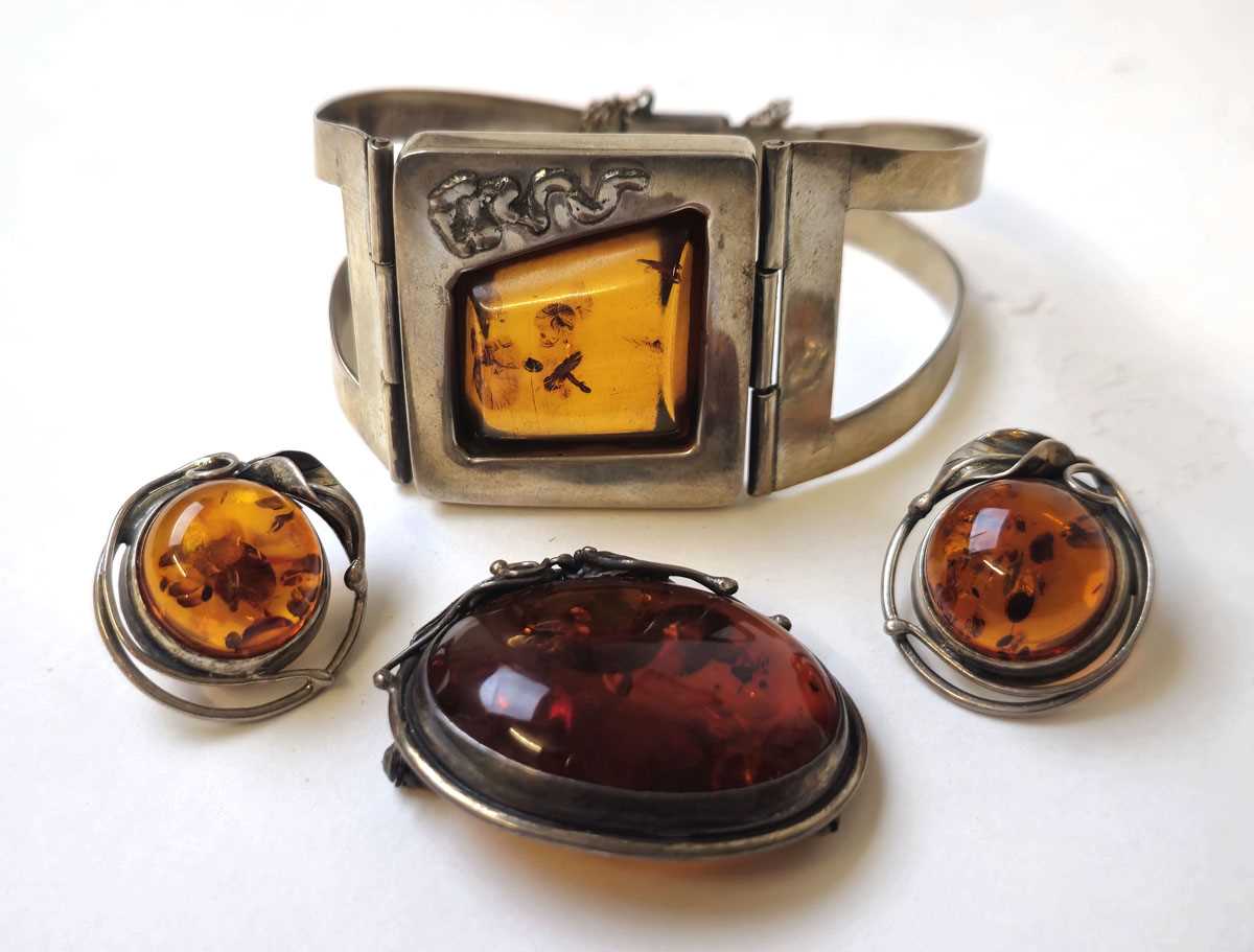 Lot 549 - A white metal and amber bracelet together with...