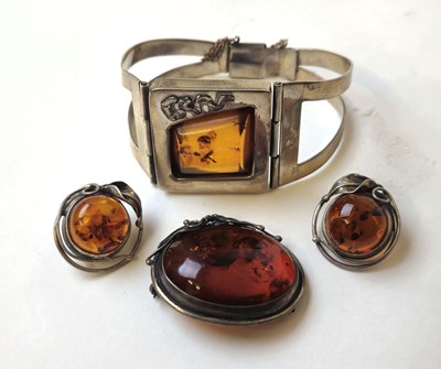 Lot 549 - A white metal and amber bracelet together with...