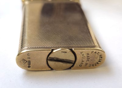 Lot 560 - A 9ct gold Dunhill arm lift lighter....