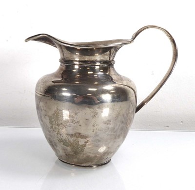 Lot 447 - A metalware milk jug of traditional plain form,...