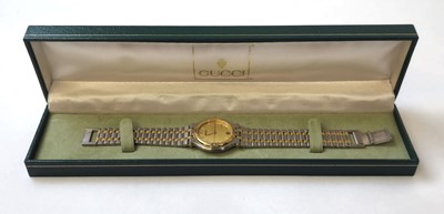 Lot 569 - A Gucci 9000M two-tone quartz wristwatch with box