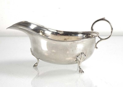 Lot 455 - A silver sauce boat of typical form on pad...