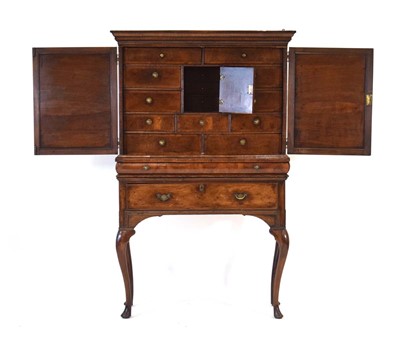 Lot 11 - An early 18th century and later walnut cabinet...