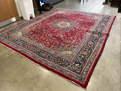 Lot 28 - A 20th century woollen carpet, the red ground...