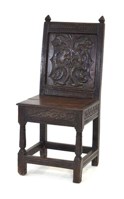 Lot 44 - A 17th century oak back stool, the solid seat...