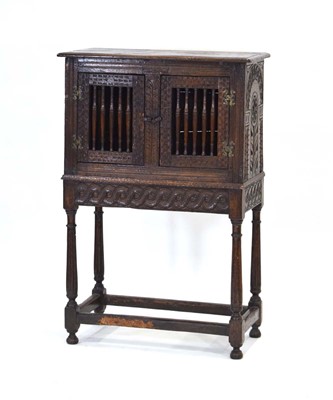 Lot 49 - A 17th century-style oak livery or dole...