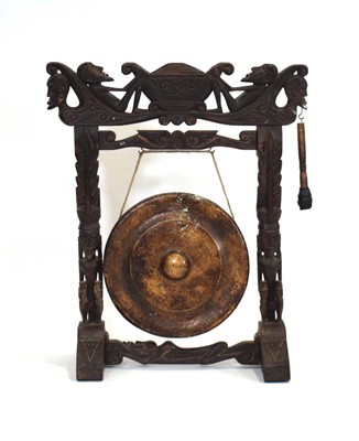 Lot 55 - A mid-20th century dinner gong, the carved...