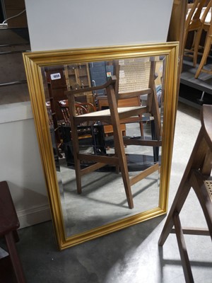 Lot 1059 - Gilt framed and beveled rectangular wall mirror