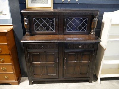 Lot 1069 - Old charm style dark oak sideboard with leaded...